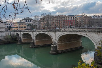 Old stone bridge over a large river in European city