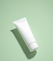 White Cosmetic Tube on Green Background – Skincare Product Mockup