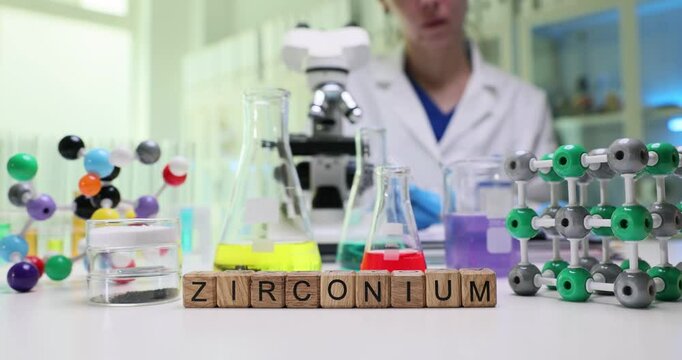 We are exploring zirconium in the lab using flasks, molecular models, and a microscope for analysis