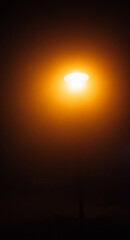 A street light is lit up in the dark