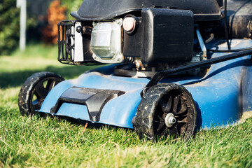 A lawn mower is on a grassy field