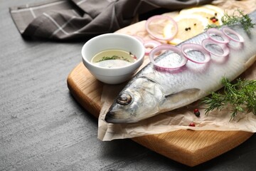 Tasty herring with spices on black table, closeup