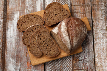 Pieces of fresh bread on wooden table, top view