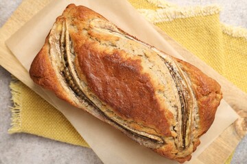 Homemade banana bread on grey table, top view
