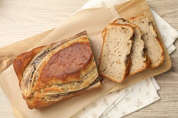 Cut banana bread on wooden table, top view