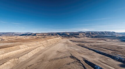 Naklejka premium aerial view of vast empty quarry with clear terraced layers and abundant blank sky above for copy space