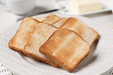 Slices of tasty toasted bread on white table, closeup