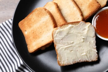 Slices of tasty toasted bread with butter and jam on table, top view