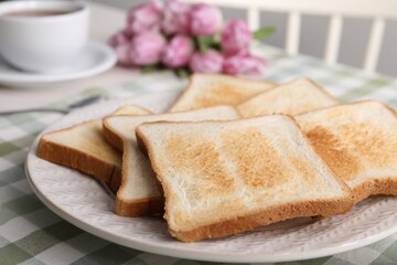 Tasty crispy toasted bread slices on table, closeup