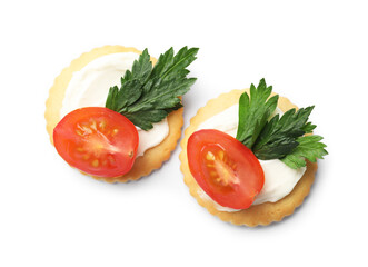 Tasty crackers with cream cheese, tomatoes and parsley isolated on white, top view