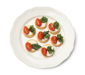 Tasty crackers with cream cheese, tomatoes and parsley isolated on white, top view