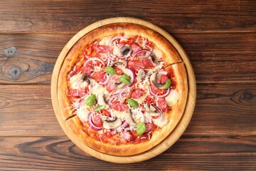 Tasty pizza with smoked sausages and mushrooms on wooden table, top view