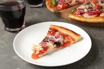 Slice of tasty pizza with thin smoked sausages served on grey table, closeup