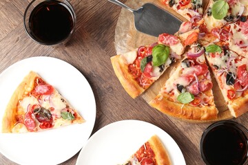 Slices of tasty pizza with thin smoked sausages served on wooden table, flat lay