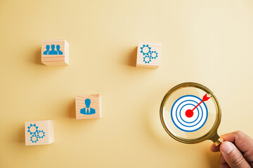 Focus through magnifying glass on te target icon, which embodies start-up, creative ideas, and...