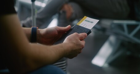 International Airport Terminal: Close Up of Man with Suitcase Sitting in Boarding Lounge of Airline...