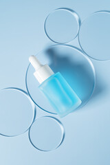 Petri dish with cosmetic product, bottle and pipette on light blue background, flat lay