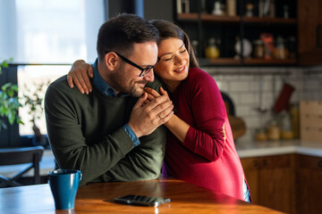 Man in love hugs his pregnant wife, they are waiting together for the baby's arrival. Love, family