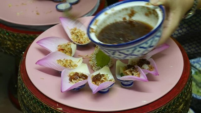 Making Miang Kham (traditional Southeast Asian herbal snack from Thailand and Laos), Traditional Thai snack. It&rsquo;s a snack containing different ingredients of herbs and vegetables. 