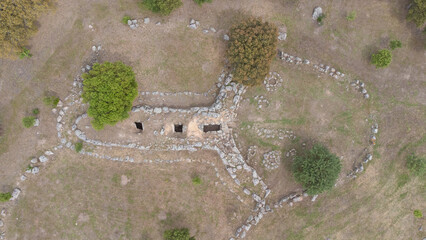 Drone shot of the prehistoric Giants' Tomb of San Cosimo, showcasing its megalithic layout