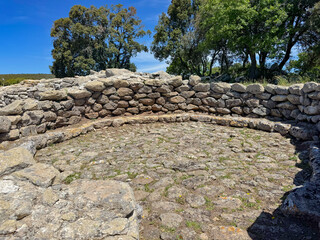 Ancient stone-lined sacred well filled with water, part of the Nuragic sanctuary of Santa Vittoria in Serri