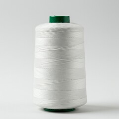 Close-up of a spool of white sewing thread.
