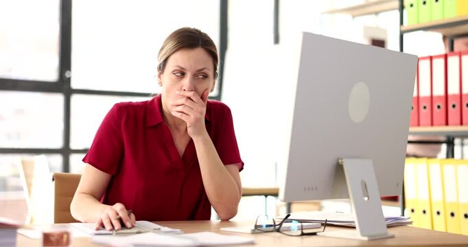 Male manager whispers secret to surprised female colleague sitting at desk in office. Man shares confidential information and gossiping at workplace