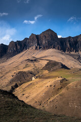 Off-road along the mountain range. Beautiful mountains with autumn grass and colorful blue sky