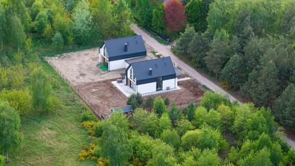 Modern Passive Semi-Detached House in Spring – Immersed in Fresh Greenery, Eco-Friendly Living, a contemporary semi-detached house designed for sustainable living, surrounded by lush spring.