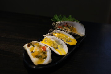 Oysters platter with lemon and ice served on a bar counter. High quality photo
