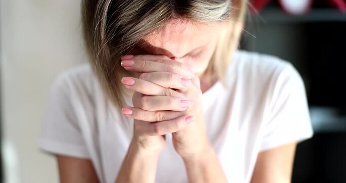Woman joins hands in prayer bowing head in moment filled with reflection devotion and hope. Serene and contemplative spirit during pray worship