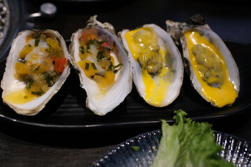 Deliciously Grilled Oysters Topped with Savory Garnish and Aromatics . High quality photo