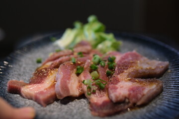 Slice of fresh raw slices Kurobuta pork with high-marbled texture on white plate isolated on white background. High quality photo