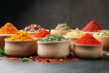 Different aromatic spices on black table, closeup