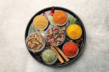 Different aromatic spices on light grey table, top view