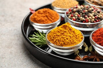 Different aromatic spices on light grey table, closeup