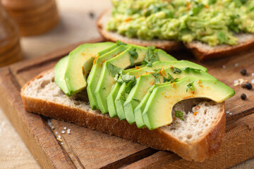 Healthy avocado toast on wooden board. Vegan snack food
