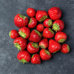 Fresh strawberries on black slate background