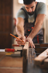 Young carpenter working in his workshop