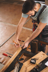 Young carpenter working in his workshop