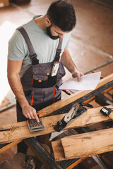 Young carpenter working in his workshop