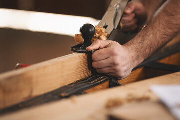 Young carpenter working in his workshop