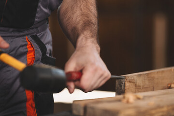 Young carpenter working in his workshop