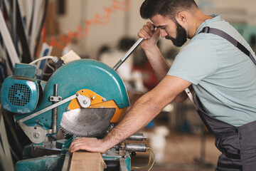 Young carpenter working in his workshop