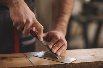Young carpenter working in his workshop