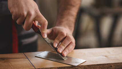 Young carpenter working in his workshop