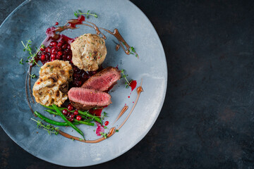 Traditionally roasted fillet of saddle of venison with bread dumplings, mushrooms and bean sticks...