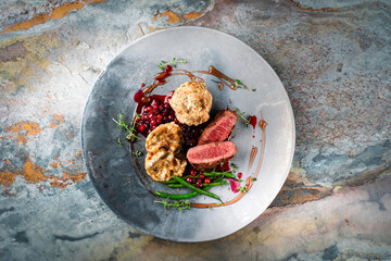 Traditionally roasted fillet of saddle of venison with bread dumplings, mushrooms and bean sticks...
