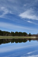 Reflection on the lake in spring, Sainte-Apolline, Québec, Canada