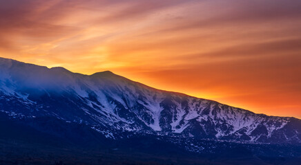 highland mountain landscape of beautiful sunset or sunrise behind nice mountain peaks and slopes in...